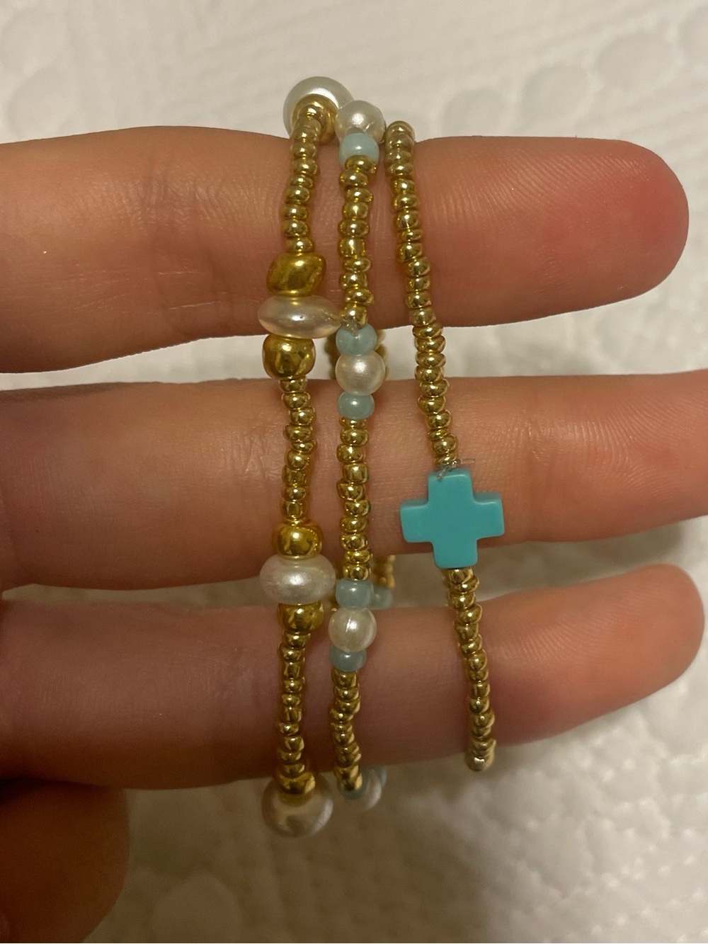 SET OF 3 gold, pearl, blue bracelet with a enewton cross.